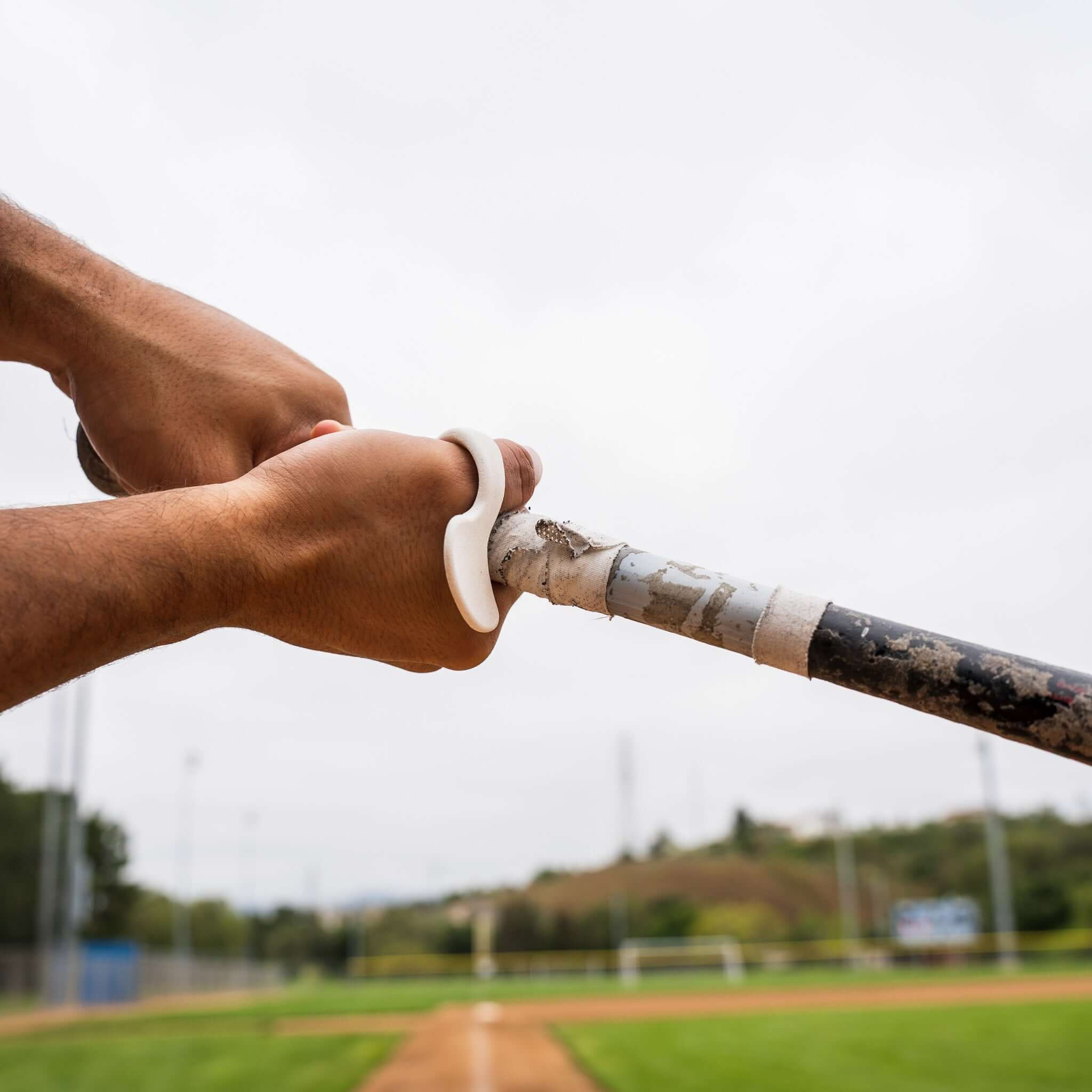 Baseball thumb protector on hand during swing